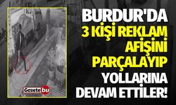 Burdur'da 3 kişi reklam afişini parçalayıp yollarına devam ettiler!