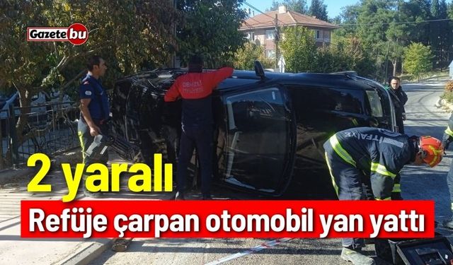 Refüje çarpan otomobil yan yattı; 2 yaralı