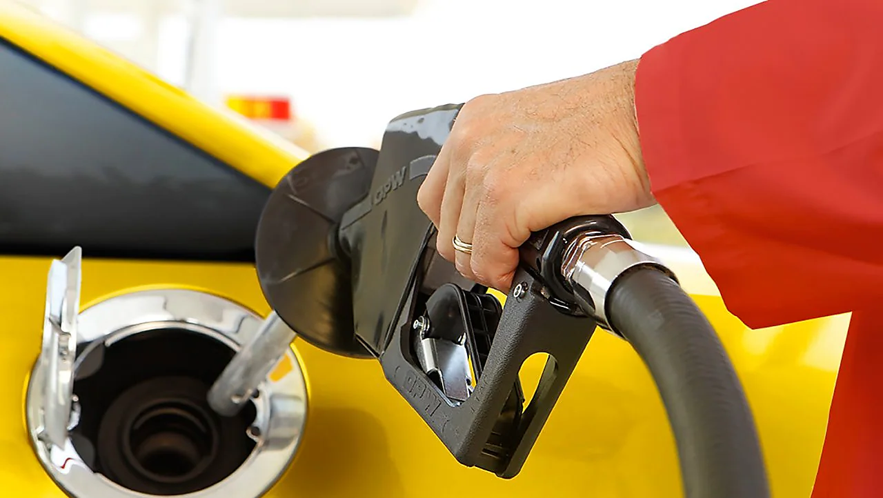 Person Filling Fuel At Fuelstation